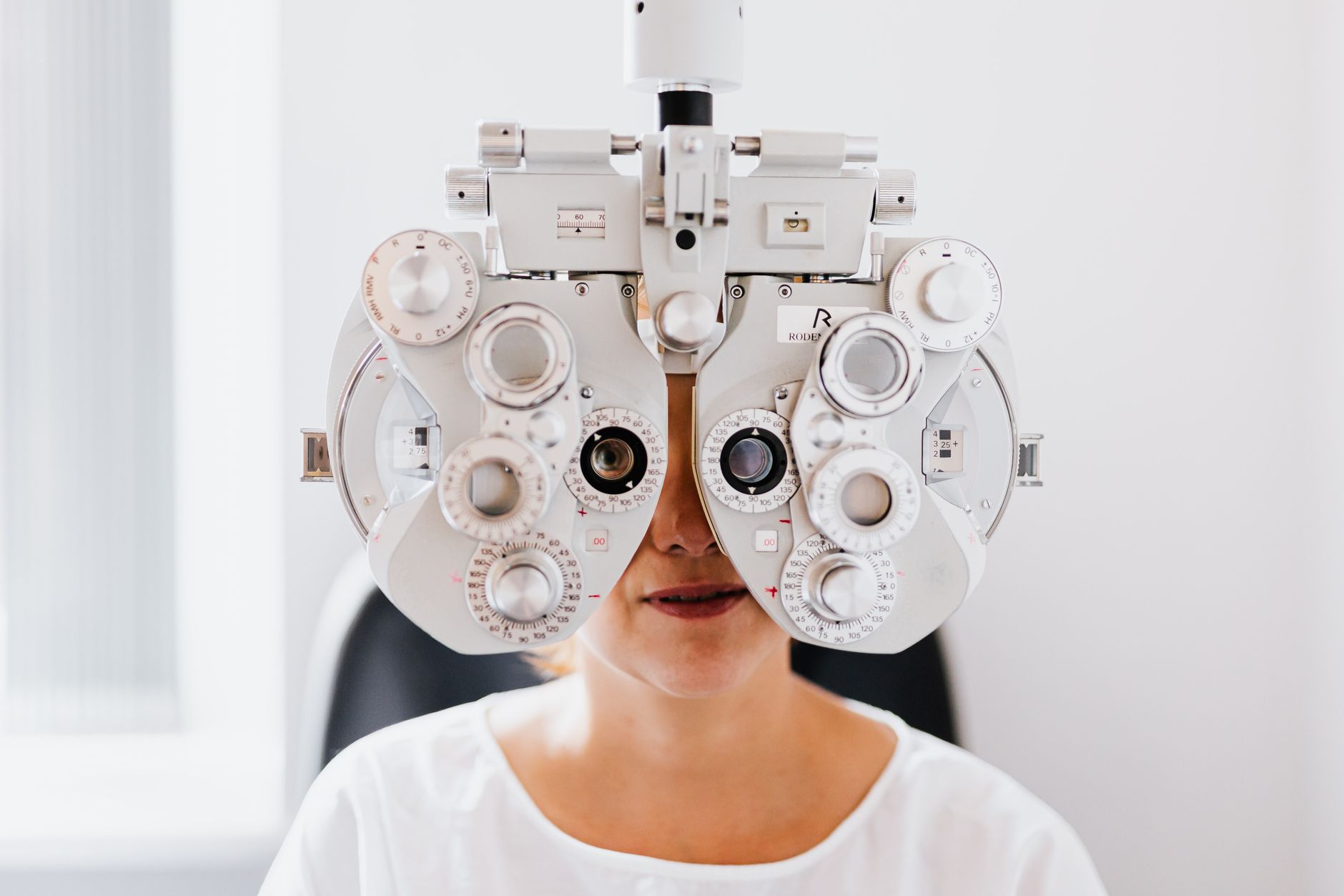 Eye test with a phoropter at the eye doctor