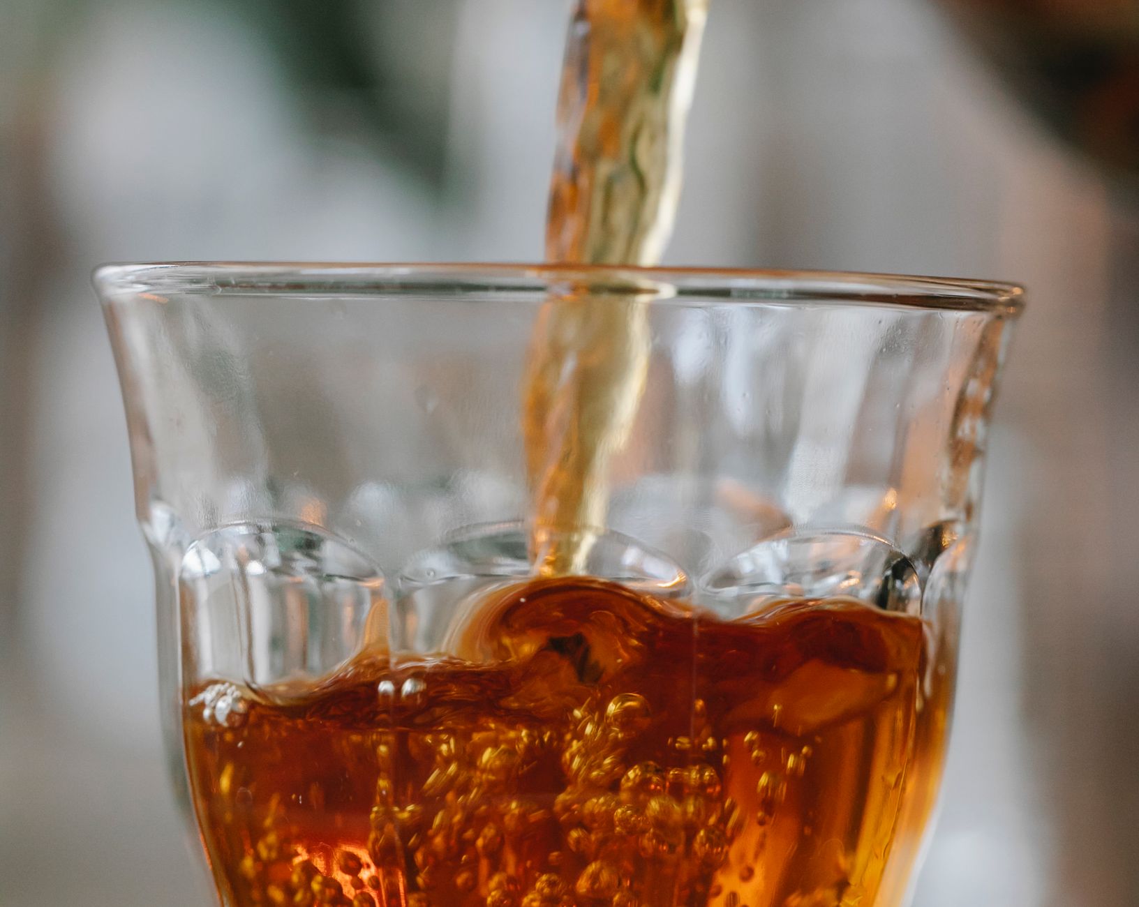 Black tea being poured into a glass