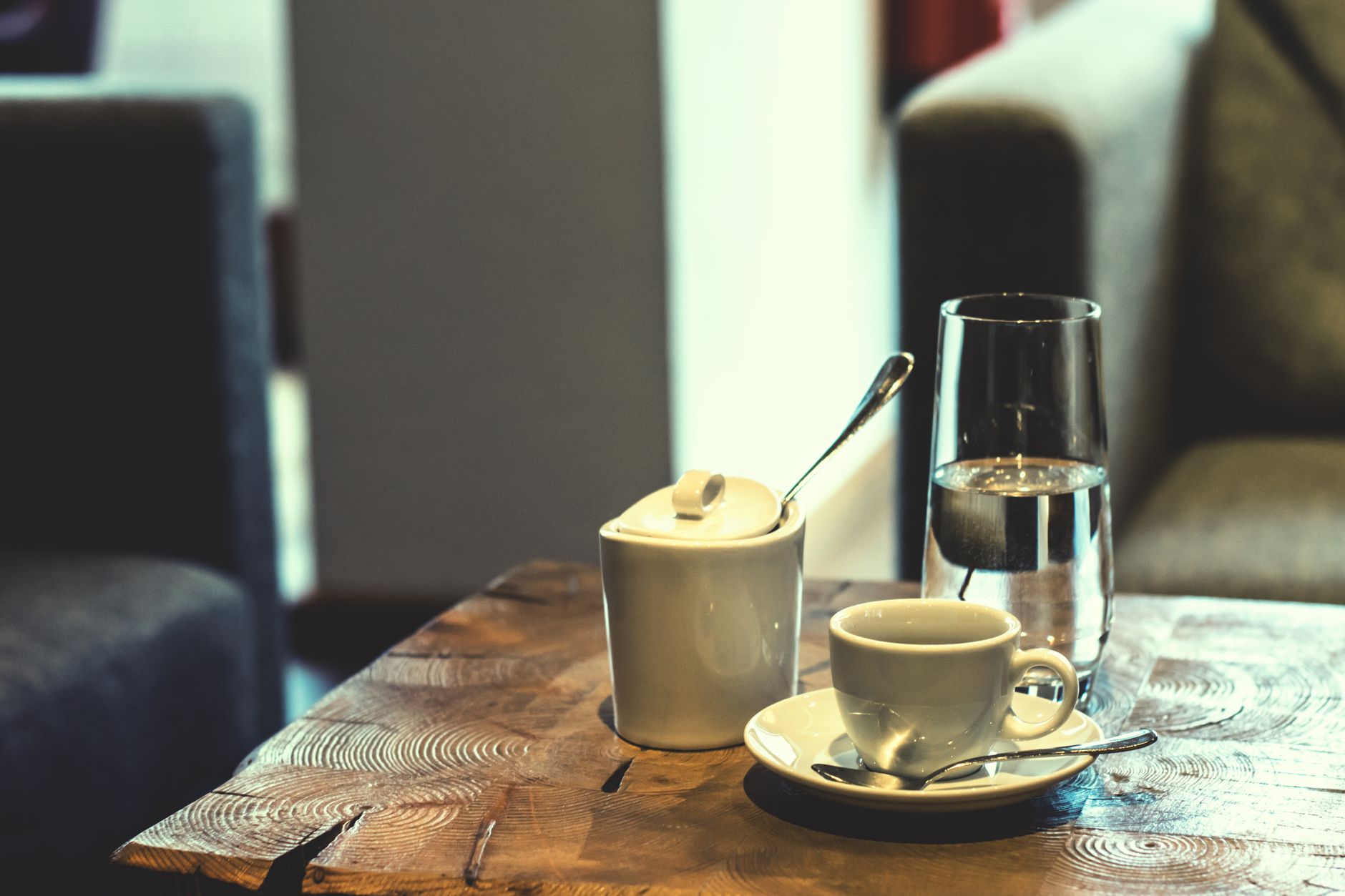 Espresso cup and a glass of water on a wooden table