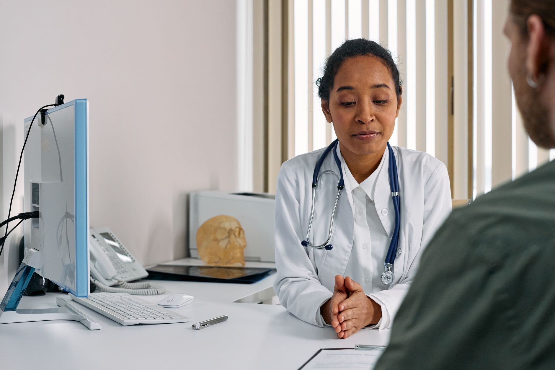 Doctor in the consulting room in conversation with a patient